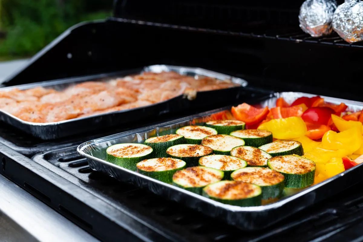 Trays of grilled meat and vegetables