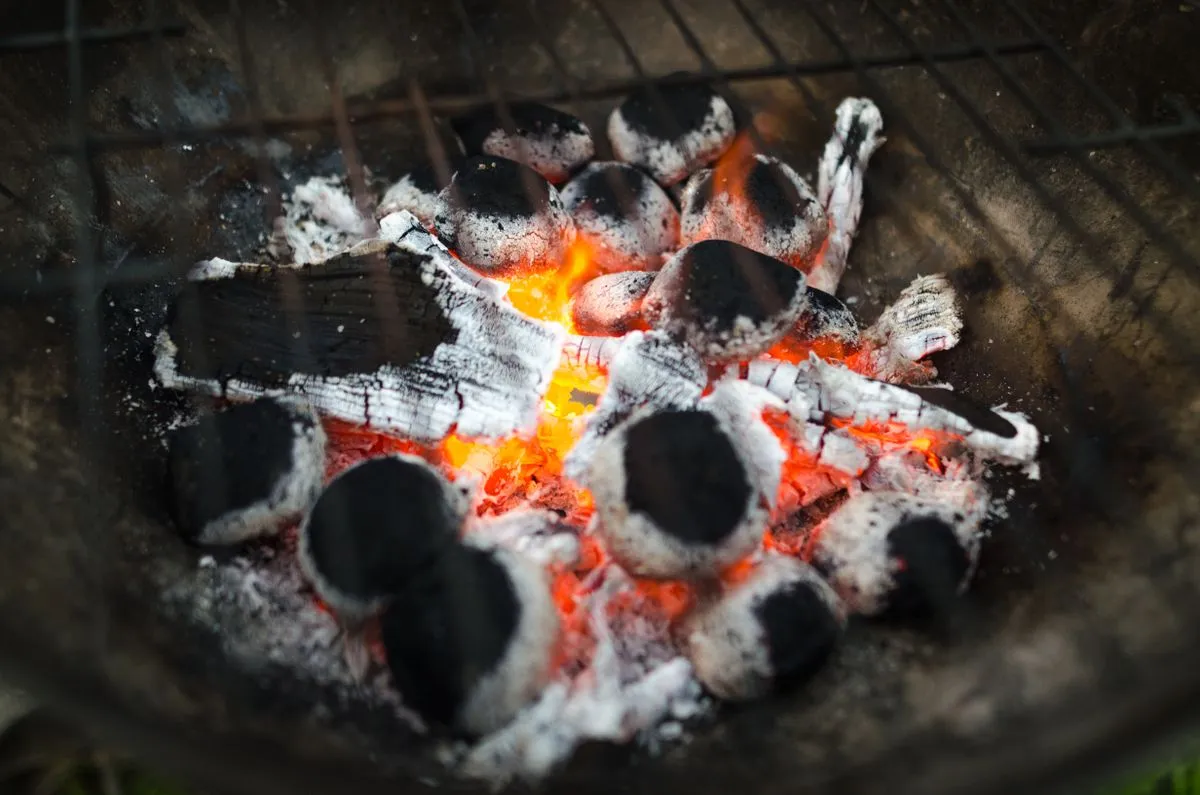 Still-glowing charcoal with gray ash