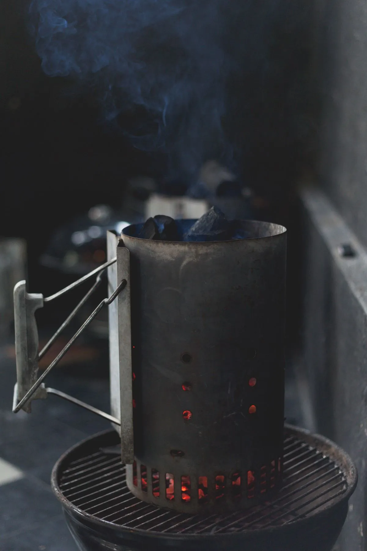 Charcoal chimney standing inside a grill