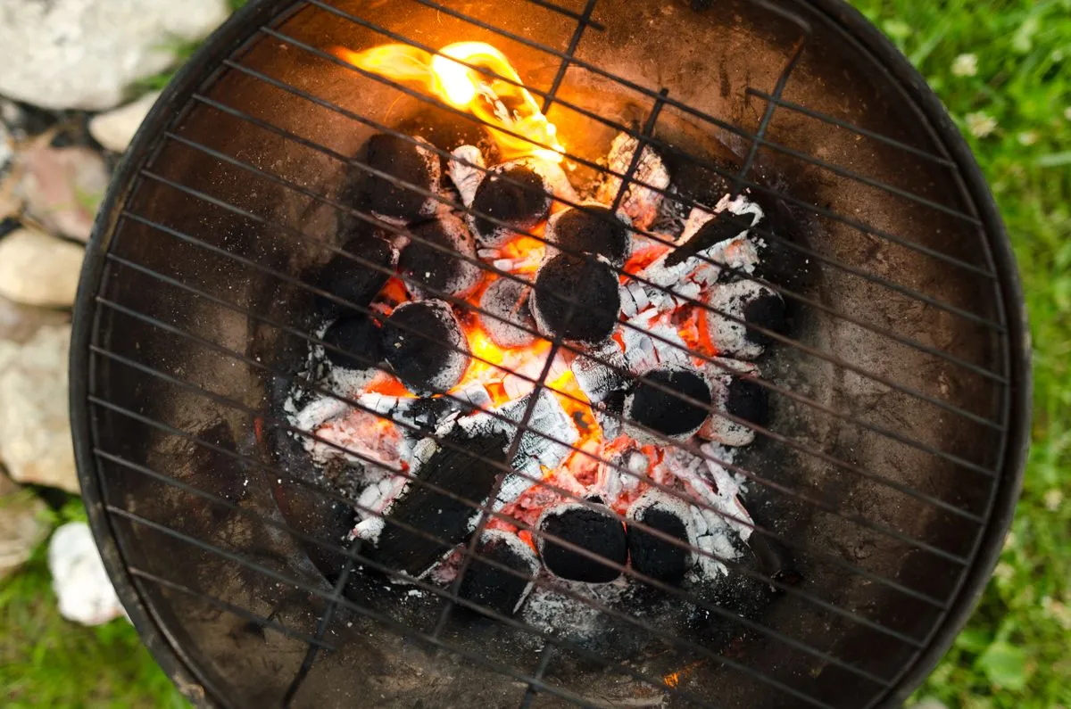 Charcoal underneath a barbecue grate