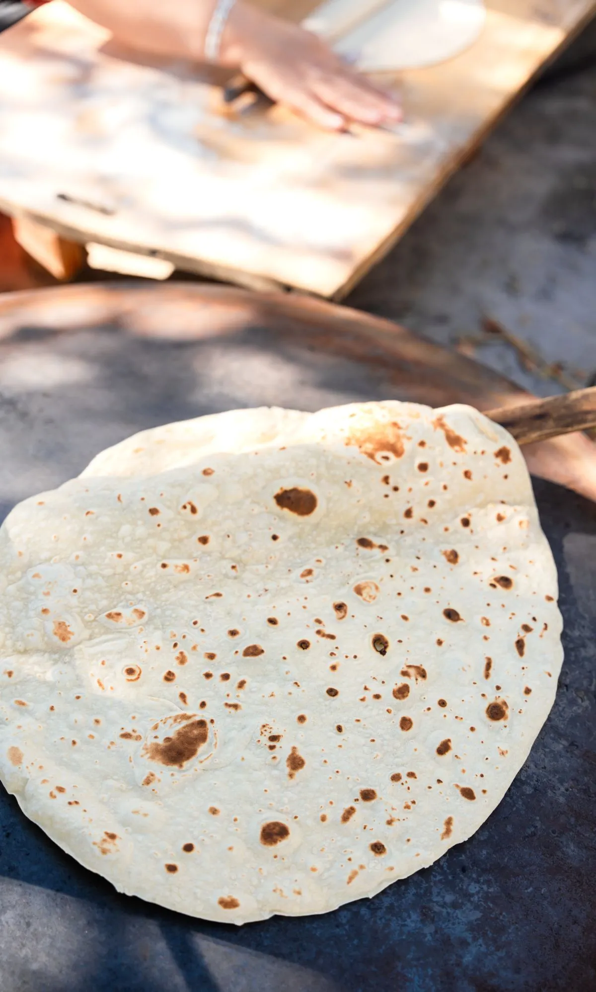 Flatbreads cooking on an outdoor griddle