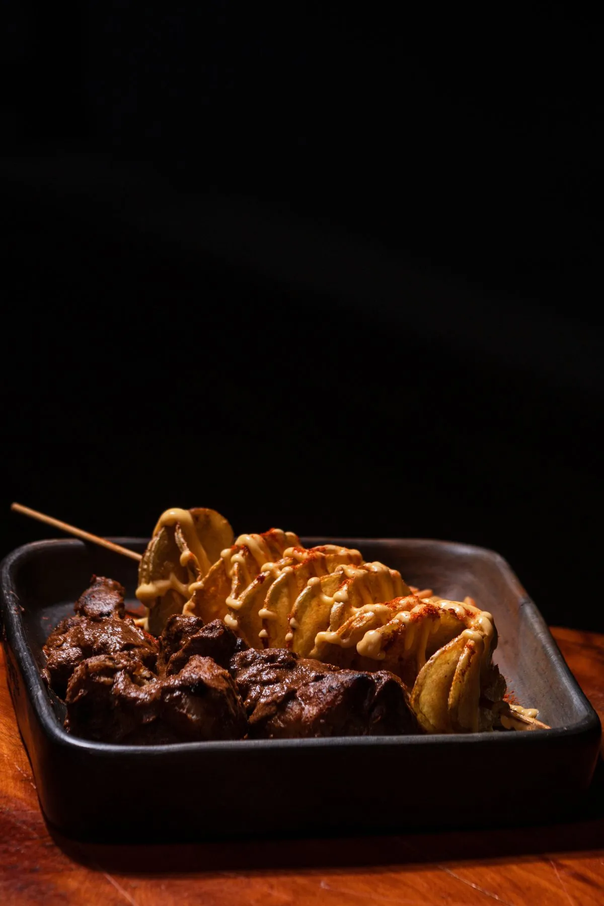 Meat and potato skewers on a plate
