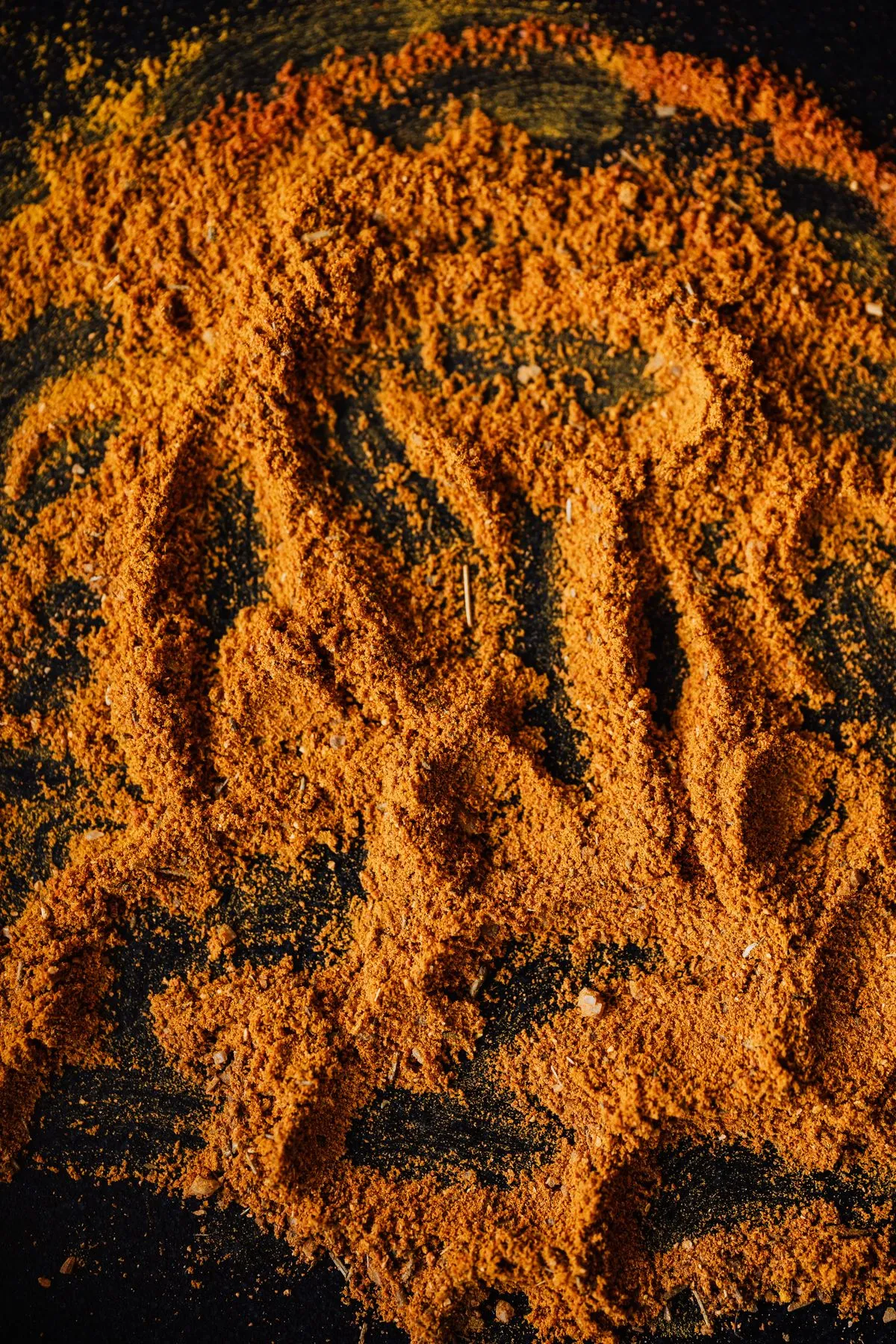 Ground spices on a dark surface