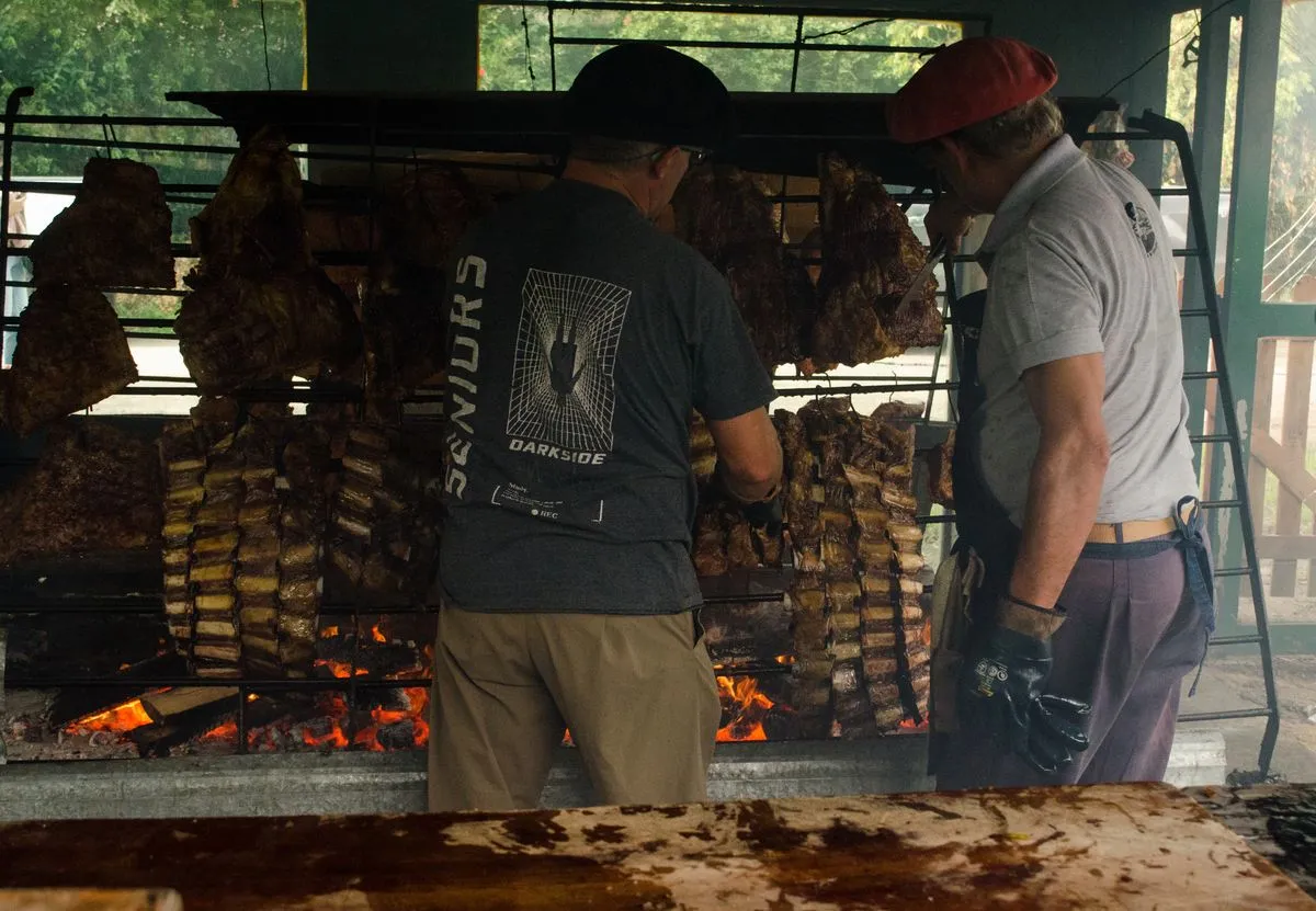 A rotisserie cooking meat outdoors