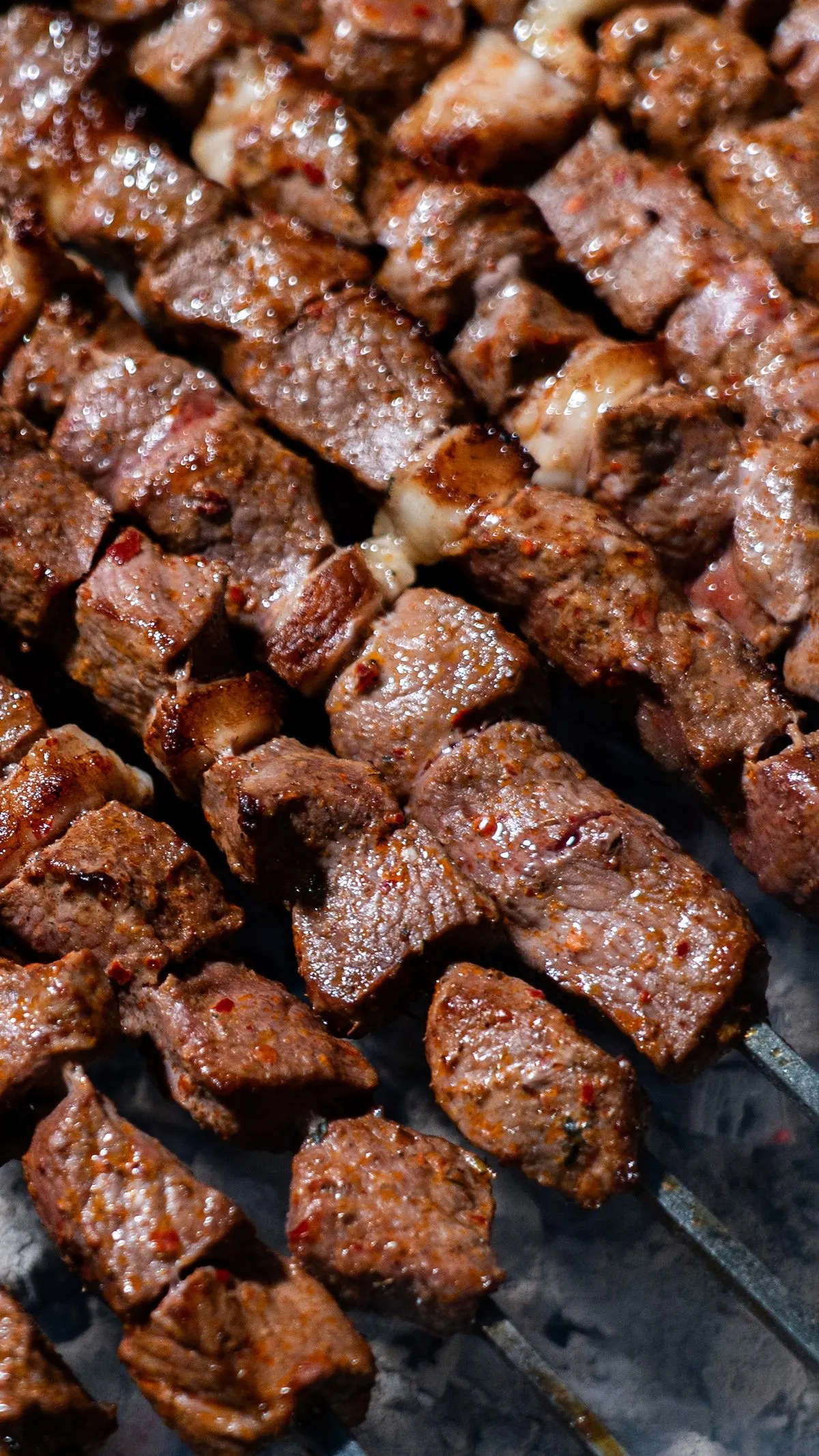 Beef cubes cooking on skewers