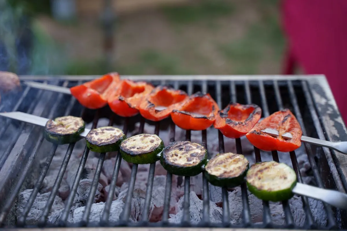 Skewers arranged on a barbecue grate