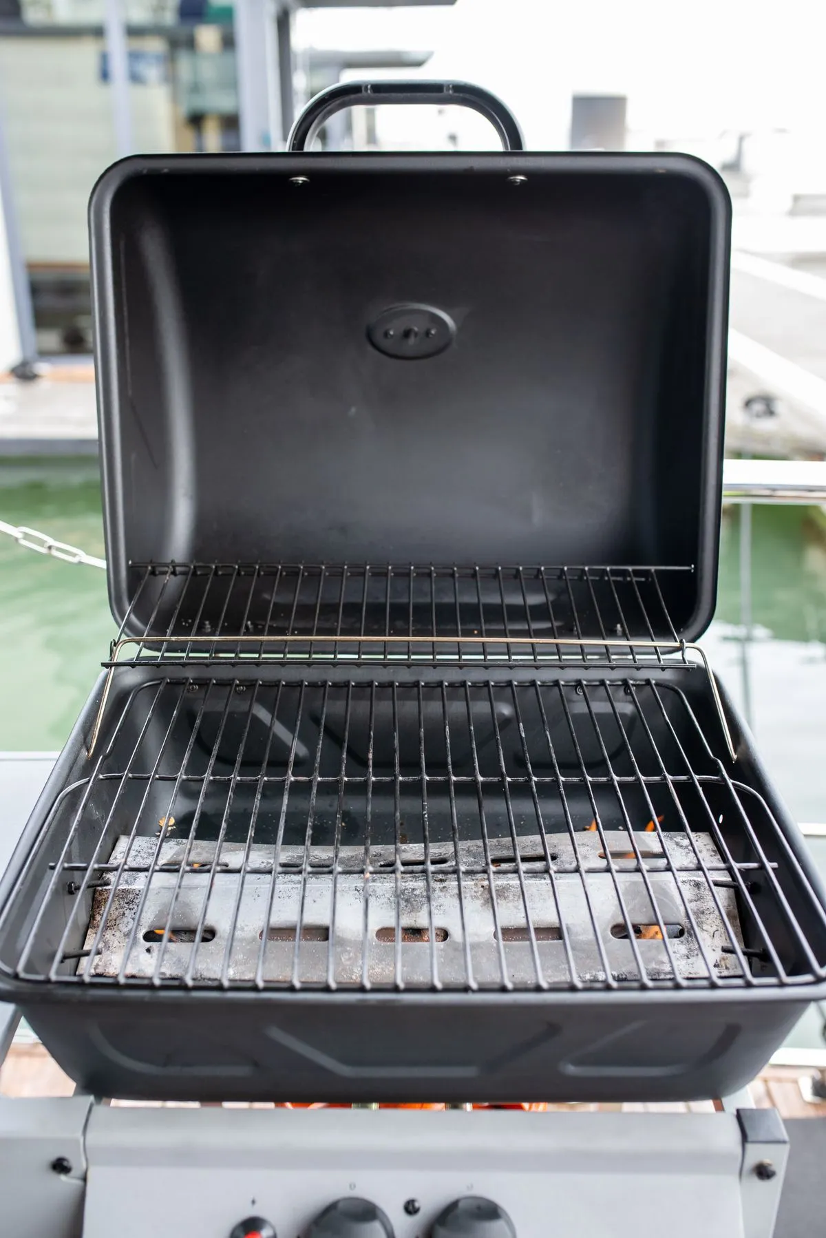An empty barbecue grill in a backyard