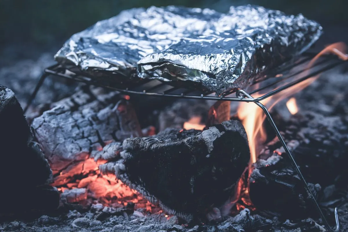 Foil-wrapped parcels on a grill
